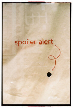 Spoiler Alert Sign on Minimal Textured Background
