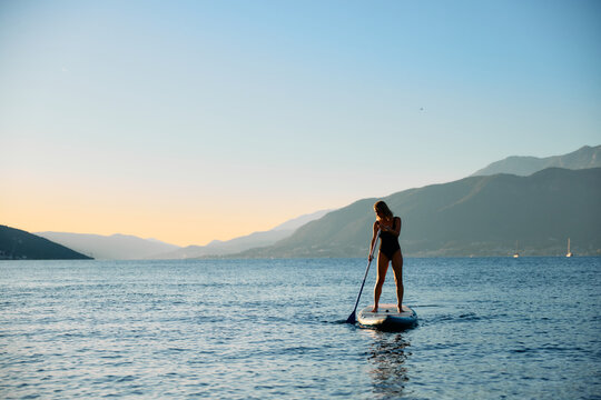 Woman Paddleboarding SUP on sea