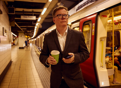 Businessman steps out of an underground train