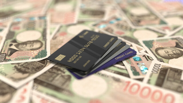 Black credit cards stacked on japanese yen banknotes.