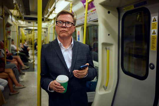 Elderly businessman commutes by subway train