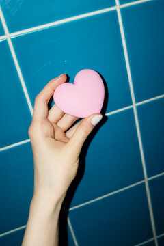 Hand holding cute pink heart shaped love pocket make up mirror