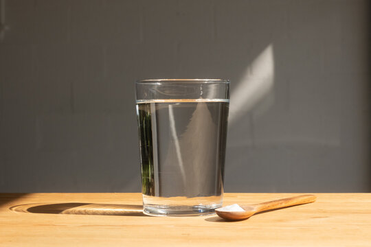 Glass Of Water and Supplement Powder in Spoon