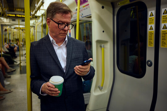 Elderly businessman travels by subway train