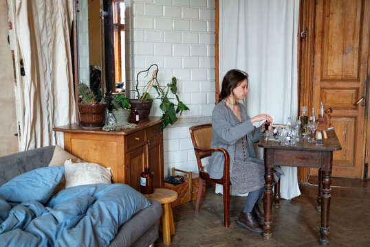 Perfumer crafting a custom fragrance in a studio workspace