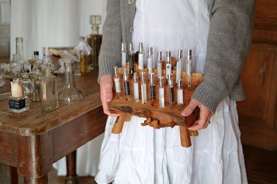 erfumer holding fragrance samples standing in studio doorway