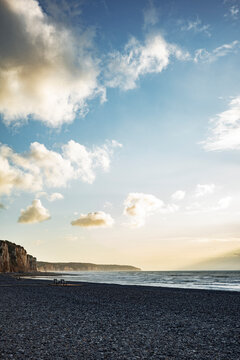 Cliffs and Beach at Sunset With Calm Water and Clear Sky