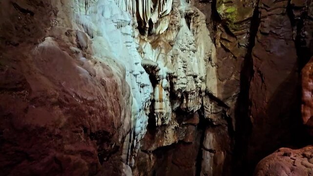 Illuminated rock formations create a dramatic scene deep within Moaning Caverns
