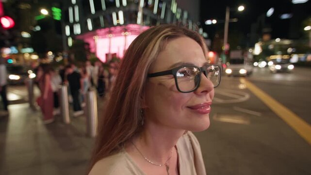 Female traveler looking at the sparkling night lights of Singapore City with modern architecture vibrant streets and memorable travel destination in Asia