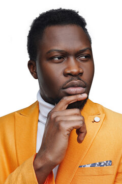 Thoughtful young black man holding his chin while looking away