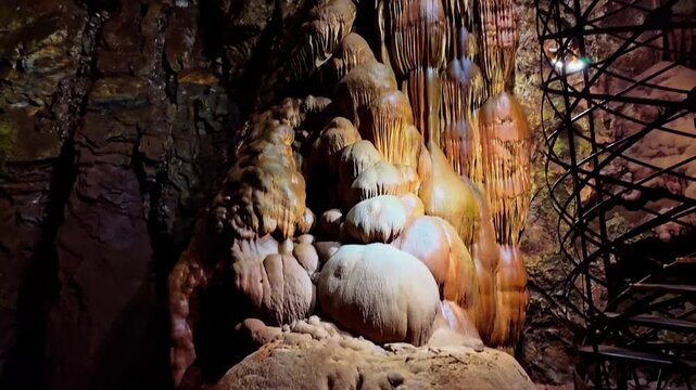 Illuminated stairway spirals through the dramatic rock formations of Moaning Caverns
