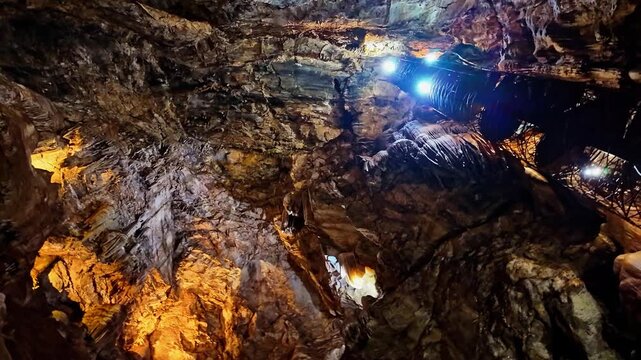 Illuminated stairway spirals through the dramatic rock formations of Moaning Caverns
