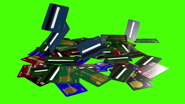 Many credit cards falling and piling up on a green screen.