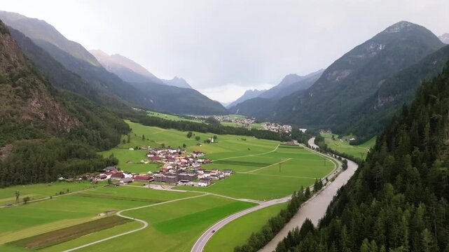 Drone panorama of picturesque alpine villages in Tyrol Austria featuring beautiful mountain valleys rugged peaks evergreen forests and European tourism