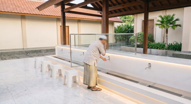 Muslim Performing Ablution at Modern Mosque Washing Area