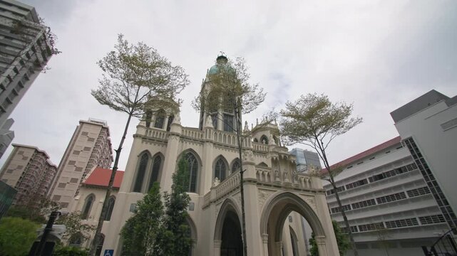 Saint Joseph Church in Singapore city featuring historic Catholic architecture surrounded by modern office skyscrapers creating a unique urban landscape for tourism in Asia