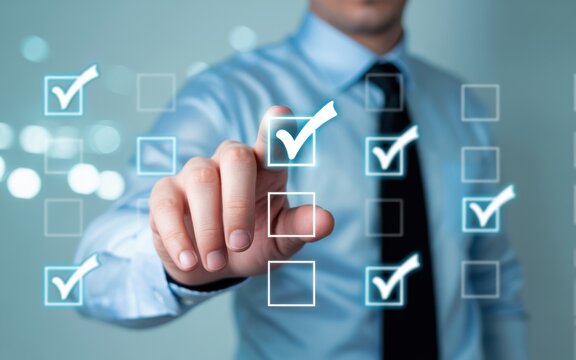Business professional selecting success checkboxes on digital interface with futuristic glow