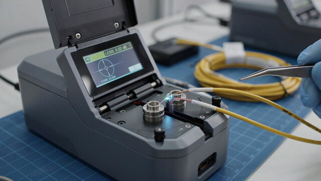 Professional fiber optic fusion splicer machine calibrating precise cable connections daily.