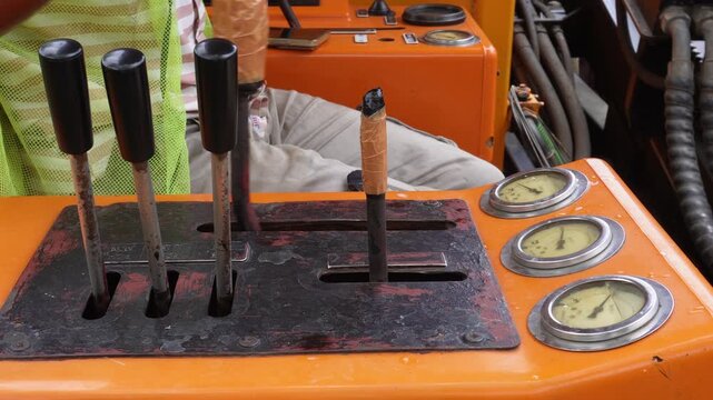 Old crane truck hydraulic control levers in action