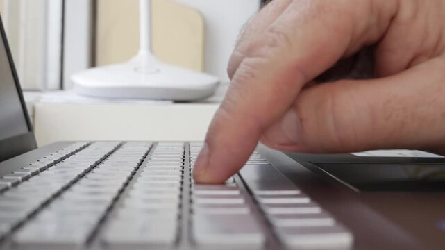 Hand Typing on Laptop Keyboard Closeup Detail
