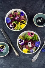 Vegetarian gourmet salad with edible flowers and fresh greens. © nikolaydonetsk