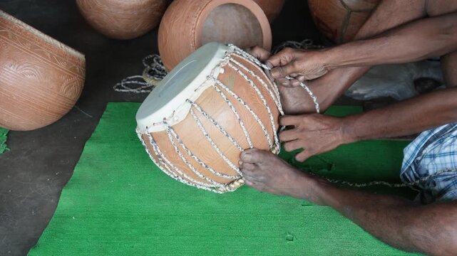 Traditional tabla dholak crafting with skilled hands
