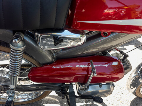 TAVERNES BLANQUES, SPAIN - JUNE 14, 2026.Close up view of the red frame and engine casing of a vintage Derbi Antorcha Olimpica Campeona moped in a sunny outdoor setting