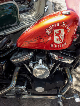 TAVERNES BLANQUES, SPAIN - JUNE 14, 2026.High angle shot shows red teardrop fuel tank with lion logo on Sueca Iron Cycles chopper motorcycle at local custom bike show