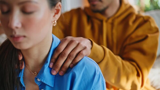 Closeup boyfriend massaging girlfriend shoulders at home. Caring partner relaxes