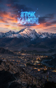 Snow capped Stok Kangri peak overlooking illuminated Leh valley at twilight Ladakh