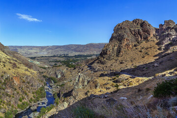 Mountain landscape along Kura river on the way to Vardzia, Georgia. Beautiful historic canyon valley scenery © borisb17