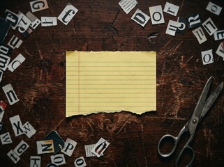 Ransom Note Mockup Flatlay with Blank Yellow Paper Cutout Newspaper Letters and Vintage Scissors on Wooden Desk © Md Limon islam