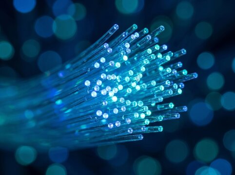 Glowing Blue and Cyan Fiber Optic Cables Transmitting High Speed Data with Bokeh Background