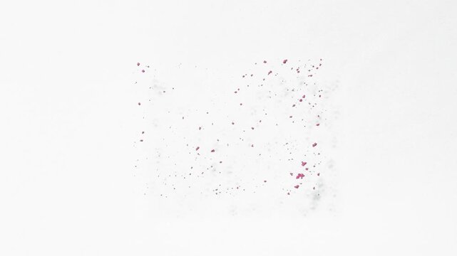 Top view perspective slow-motion shot of pink powder sifted in a rectangular shape on a blank white background swept away by an air stream | Advertising idea for blush