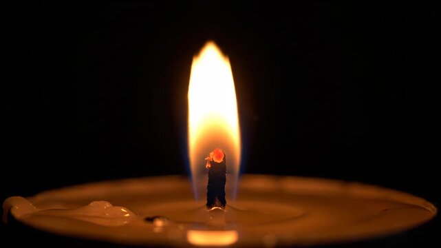 Close up of a lit wick on a traditional lamp.