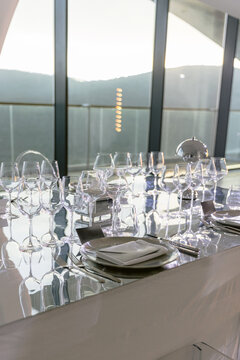Elegant fine dining table setting with glassware prepared for luxury event or wedding reception