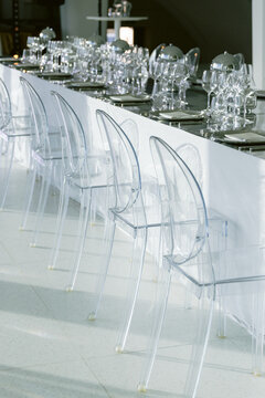 Transparent chairs and banquet table prepared for luxury event