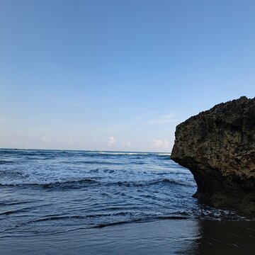 Majestic Coastal Rock Formation Framing the Tropical Waves of Parangtritis Beach Yogyakarta Indonesia