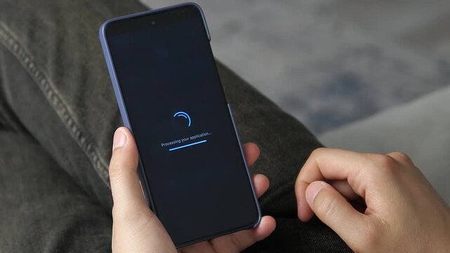 User celebrating an instant mortgage approval notification on a mobile app. Essential footage for stories on financial achievement, homeownership milestones, and life success.