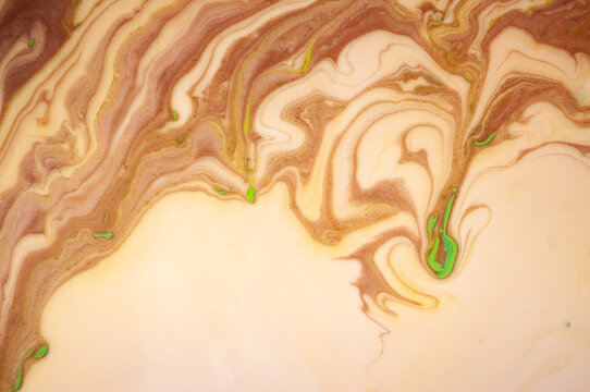 Abstract brown and green swirl patterns on a light background