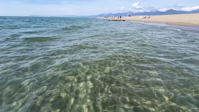 Panoramic view Tuscany coast beautiful sand beach with clear turquoise sea water in Tuscany, Italy.