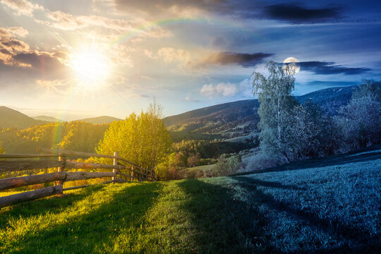 day meet night in mountainous rural landscape in spring. epic view of valley fields at twilight. sun and moon over alpine meadow. carpathian mountains countryside with forest near pasture. harmony