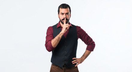 Fototapeta premium Man with Finger on Lips in Vest, Shushing for Quiet Isolated on White