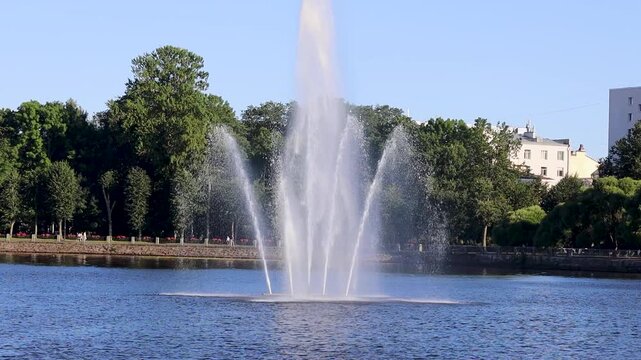A fountain spewing water into the air in the middle of a serene lake