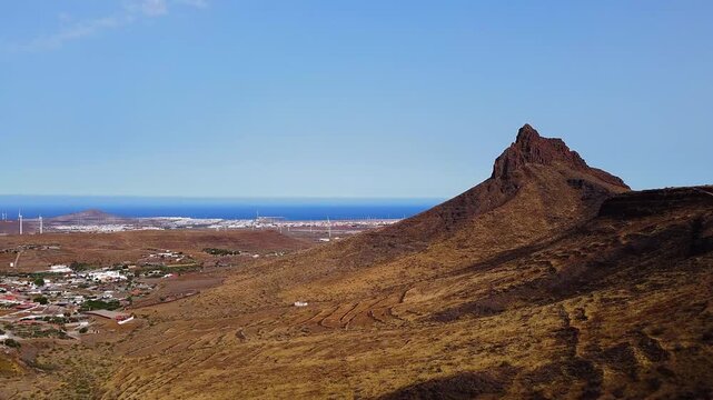 Aerial view of Arinaga mountain landscape and wind turbines in Gran Canaria