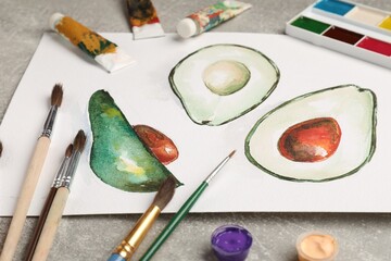 Different brushes, watercolor paints, tubes and drawing on grey table, closeup © New Africa