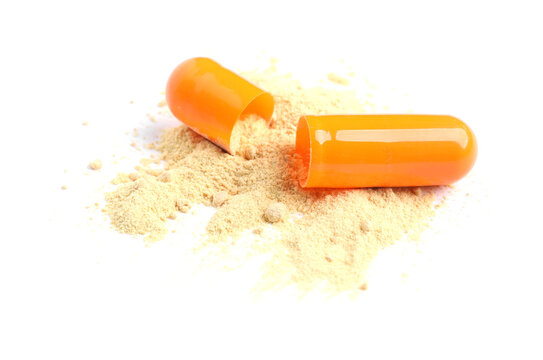 Pill. Open capsule with powder isolated on white