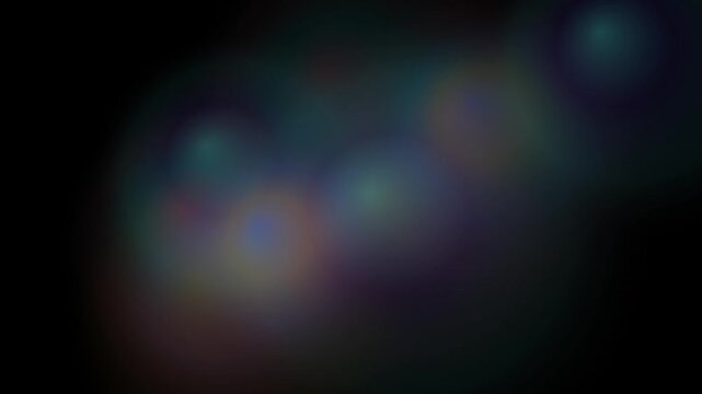 Abstract bokeh lights create a dark background with colorful lens flare effects in a seamless loop.