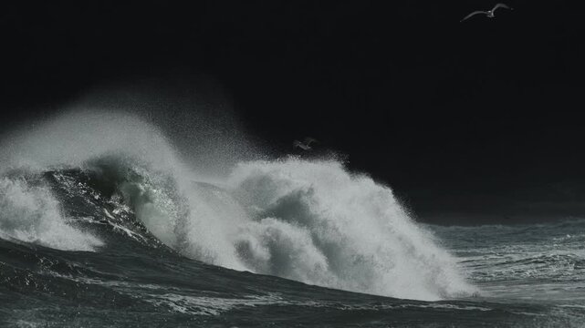 Turbulent Black Sea waves, swashing over, rising froth, dark sky, rough horizon at daytime, winter.