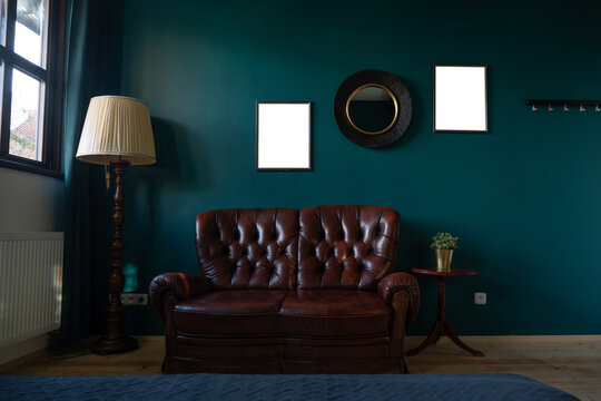 Vintage living room with leather sofa and empty frames